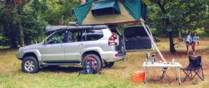 Camping table and off road vehicle in campsite